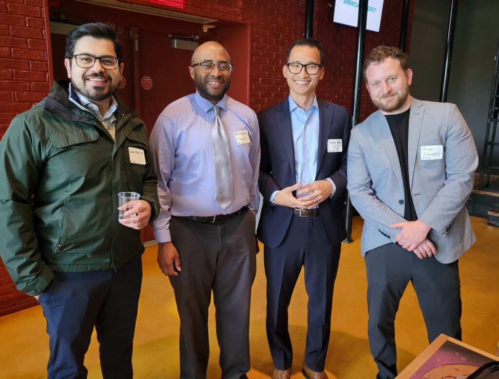 Image of four UMBC alumni at Pre-Law Networking Social